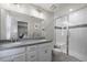 This bathroom features double sinks, great lighting, and a tile and glass shower at 13734 Ash Cir, Brighton, CO 80602