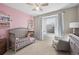 This Bedroom features lots of natural light, a gray color palette, and a comfortable rocking chair at 13734 Ash Cir, Brighton, CO 80602