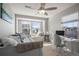 This bedroom features a bay window, ceiling fan, computer, and lots of room to relax at 13734 Ash Cir, Brighton, CO 80602