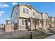 Townhouse exterior featuring neutral siding, stone accents, and a well-maintained landscape at 13734 Ash Cir, Brighton, CO 80602