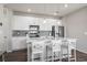 Bright kitchen featuring white cabinets, a center island, and stainless steel appliances at 13734 Ash Cir, Brighton, CO 80602