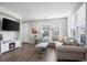 Bright living room featuring hardwood floors, recessed lighting, and a cozy fireplace at 13734 Ash Cir, Brighton, CO 80602