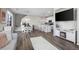 Open-concept living space with hardwood floors, modern decor, and a stylish kitchen at 13734 Ash Cir, Brighton, CO 80602