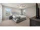 This spacious main bedroom features a gray color palette, ceiling fan, and great lighting at 13734 Ash Cir, Brighton, CO 80602