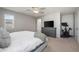 This spacious main bedroom features a gray color palette, ceiling fan, and great lighting at 13734 Ash Cir, Brighton, CO 80602