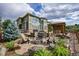 Landscaped backyard oasis with fire pit and seating area at 5965 Topaz Vista Pl, Castle Pines, CO 80108