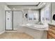 Spa-like bathroom with a large soaking tub and walk-in shower at 5965 Topaz Vista Pl, Castle Pines, CO 80108