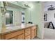 Shared bathroom with double vanity and light-colored cabinets at 5965 Topaz Vista Pl, Castle Pines, CO 80108