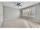 Well-lit bedroom with neutral walls and carpet at 5965 Topaz Vista Pl, Castle Pines, CO 80108