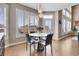 Bright dining area with round table and chairs, near kitchen and windows at 5965 Topaz Vista Pl, Castle Pines, CO 80108