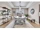 Modern dining room with a long table and contemporary lighting at 5965 Topaz Vista Pl, Castle Pines, CO 80108