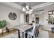 Bright dining area with a large table and view into the living room at 5965 Topaz Vista Pl, Castle Pines, CO 80108