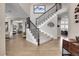 Grand entryway with hardwood floors and a curved staircase at 5965 Topaz Vista Pl, Castle Pines, CO 80108