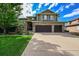 Two story home with green siding and double garage at 5965 Topaz Vista Pl, Castle Pines, CO 80108