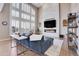 Gathering room with a linear fireplace and wall-mounted TV at 5965 Topaz Vista Pl, Castle Pines, CO 80108