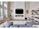 Gathering room with a modern fireplace and large windows at 5965 Topaz Vista Pl, Castle Pines, CO 80108