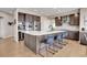 Modern kitchen with large island and stainless steel appliances at 5965 Topaz Vista Pl, Castle Pines, CO 80108