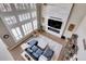 Spacious living room with a fireplace and large windows at 5965 Topaz Vista Pl, Castle Pines, CO 80108