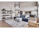 Open living room with a view into the kitchen and high ceilings at 5965 Topaz Vista Pl, Castle Pines, CO 80108