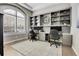 Home office with built-in shelving and two desks at 5965 Topaz Vista Pl, Castle Pines, CO 80108