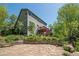 Backyard featuring stone patio and tiered landscaping up to the rear deck, with lush greenery at 15904 W 58Th Ave, Golden, CO 80403