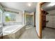 Primary bathroom featuring a soaking tub, separate shower, and walk in closet at 15904 W 58Th Ave, Golden, CO 80403