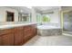 Spacious primary bathroom with a soaking tub, stand up shower, and dual sinks at 15904 W 58Th Ave, Golden, CO 80403