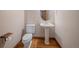 Cozy half-bathroom with a pedestal sink and wood-look vinyl floors at 15904 W 58Th Ave, Golden, CO 80403