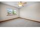 Bright bedroom featuring a ceiling fan and large window with neighborhood views at 15904 W 58Th Ave, Golden, CO 80403