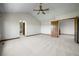 Spacious bedroom with a ceiling fan, soft carpet, and wood trim throughout at 15904 W 58Th Ave, Golden, CO 80403