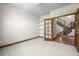 Bedroom with neutral carpet, trim and walls, and entry to a stairwell with wood steps at 15904 W 58Th Ave, Golden, CO 80403