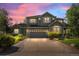Attractive two-story home with professional landscaping and a wide driveway at dusk at 15904 W 58Th Ave, Golden, CO 80403