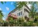 Exterior view featuring a home's side with a wooden deck and lush, tiered landscaping at 15904 W 58Th Ave, Golden, CO 80403