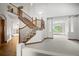 Open foyer featuring a staircase, hardwood floors and a view into the dining room at 15904 W 58Th Ave, Golden, CO 80403