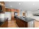 Kitchen with granite countertops, center island, wood cabinets and stainless appliances at 15904 W 58Th Ave, Golden, CO 80403
