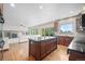 Open concept kitchen with an island, wood cabinetry, and an easy flow to the living area and outdoor deck at 15904 W 58Th Ave, Golden, CO 80403