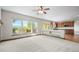 Light-filled living room with large windows offering picturesque views, opening to a modern, updated kitchen at 15904 W 58Th Ave, Golden, CO 80403