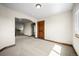 Spacious living room with gray carpet and natural wood trim throughout the space at 15904 W 58Th Ave, Golden, CO 80403
