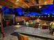 Backyard oasis with a bar, fire pit, patio umbrella, and an outdoor entertainment area at 4779 S Bannock St, Englewood, CO 80110