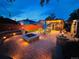 Beautifully landscaped backyard with a fire pit, dining area, and outdoor kitchen at 4779 S Bannock St, Englewood, CO 80110