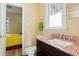 Bright bathroom features tile countertop, sink, and view to bedroom at 4779 S Bannock St, Englewood, CO 80110
