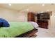 Cozy bedroom with large TV, dresser, wardrobe and carpet floors at 4779 S Bannock St, Englewood, CO 80110