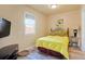 Comfortable bedroom featuring a full-sized bed, wood-look flooring and bright light at 4779 S Bannock St, Englewood, CO 80110