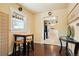 Bright dining area features hardwood floors, natural light, and seating for four at 4779 S Bannock St, Englewood, CO 80110