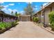 Long driveway leading to detached garage and landscaped yard with flowers at 4779 S Bannock St, Englewood, CO 80110