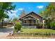 Charming home with a cozy front porch, well-manicured lawn, and quaint landscaping at 4779 S Bannock St, Englewood, CO 80110