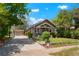 Charming home with mature trees, detached garage, and well-maintained front yard at 4779 S Bannock St, Englewood, CO 80110