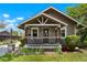 Inviting covered front porch with seating and decorative landscaping at 4779 S Bannock St, Englewood, CO 80110