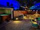 Backyard features a hot tub, stone patio, fire pit, and landscaping for relaxation and outdoor living at 4779 S Bannock St, Englewood, CO 80110