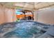 Private outdoor hot tub with a covered patio featuring an outdoor kitchen and seating at 4779 S Bannock St, Englewood, CO 80110
